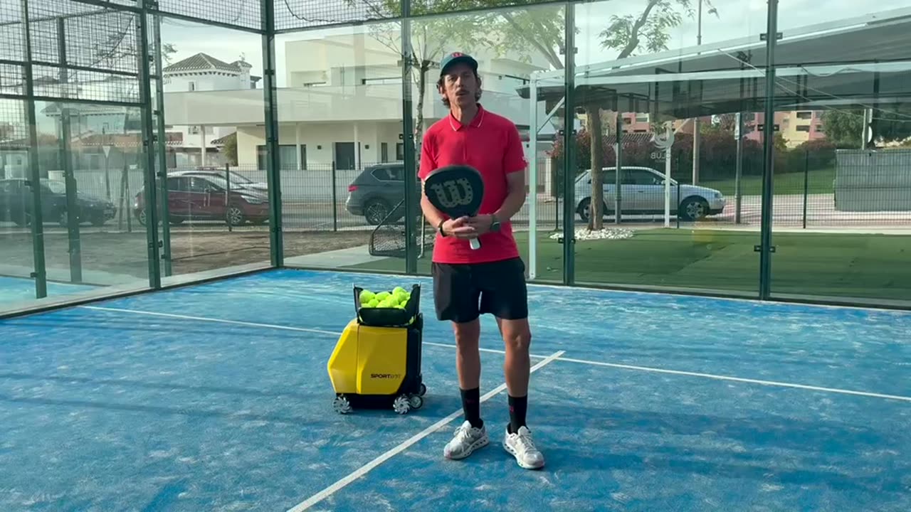 Fonsi Sernandez standing beside Sportbot on a padel court
