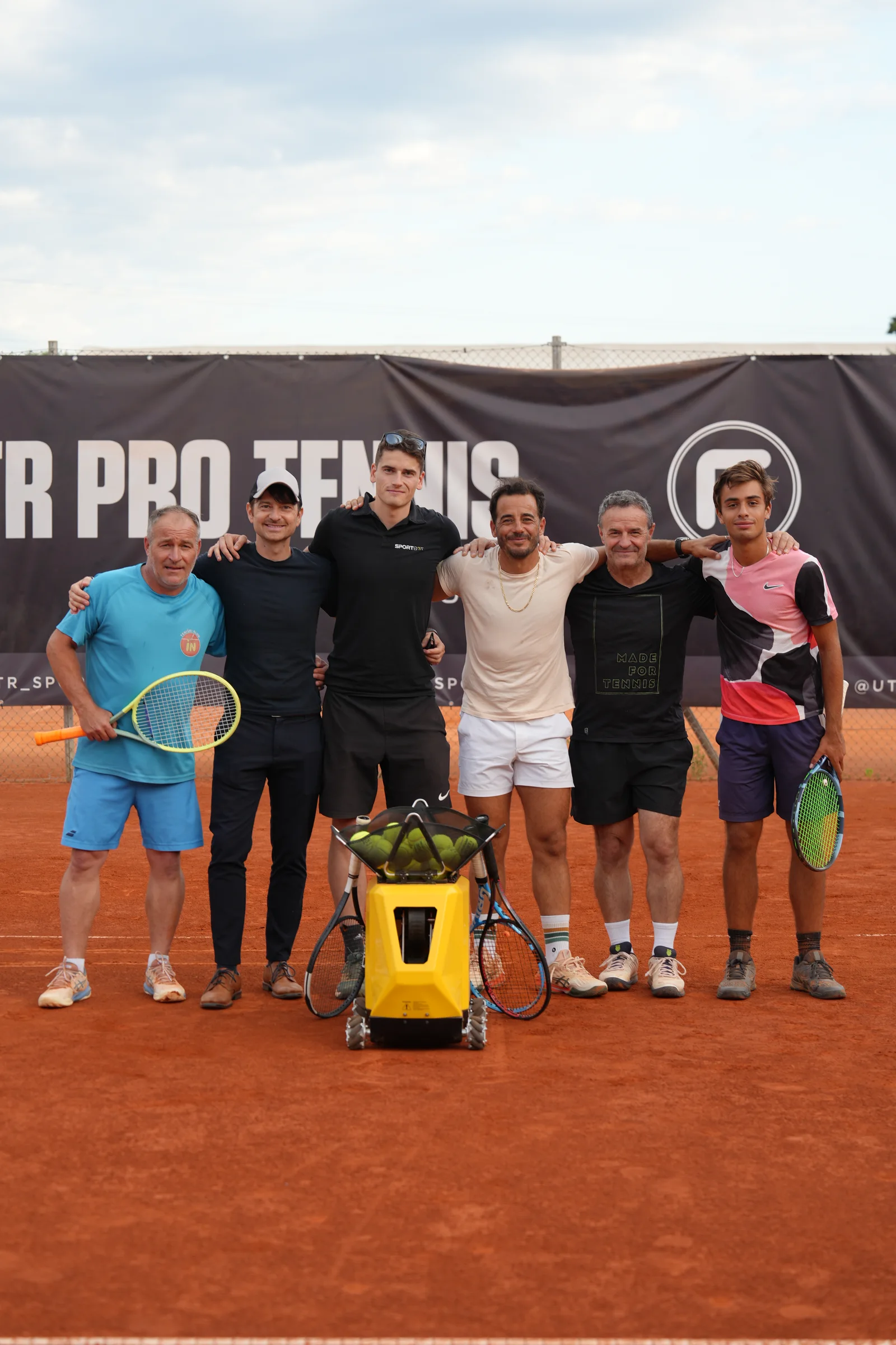 Fred Gil and the Sportbot team with the moving tennis ball machine on the clay court at UTR PTT Ljubljana