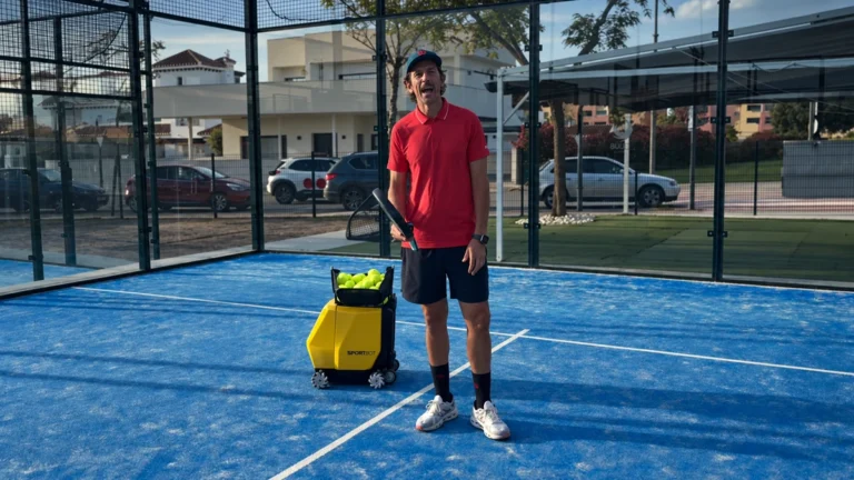 Fonsi Sernandez standing beside Sportbot on a padel court